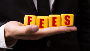 a man in a suit holding a cube with the word fees