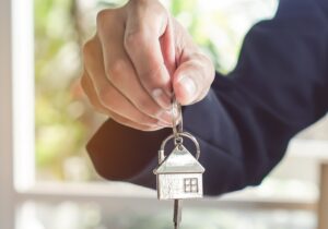 a man holding a house key in his hand