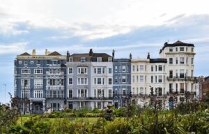 A row of buildings situated in a vast open field.