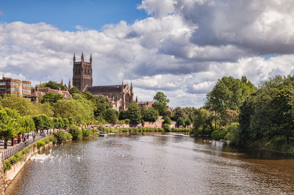 A serene river with a church nestled in the background.