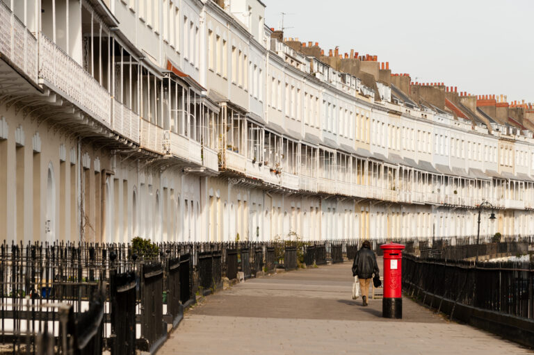 A row of diverse buildings lined up along a city street.