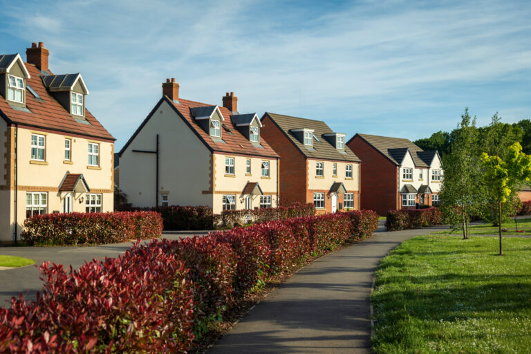 A row of houses lining a quiet residential street.